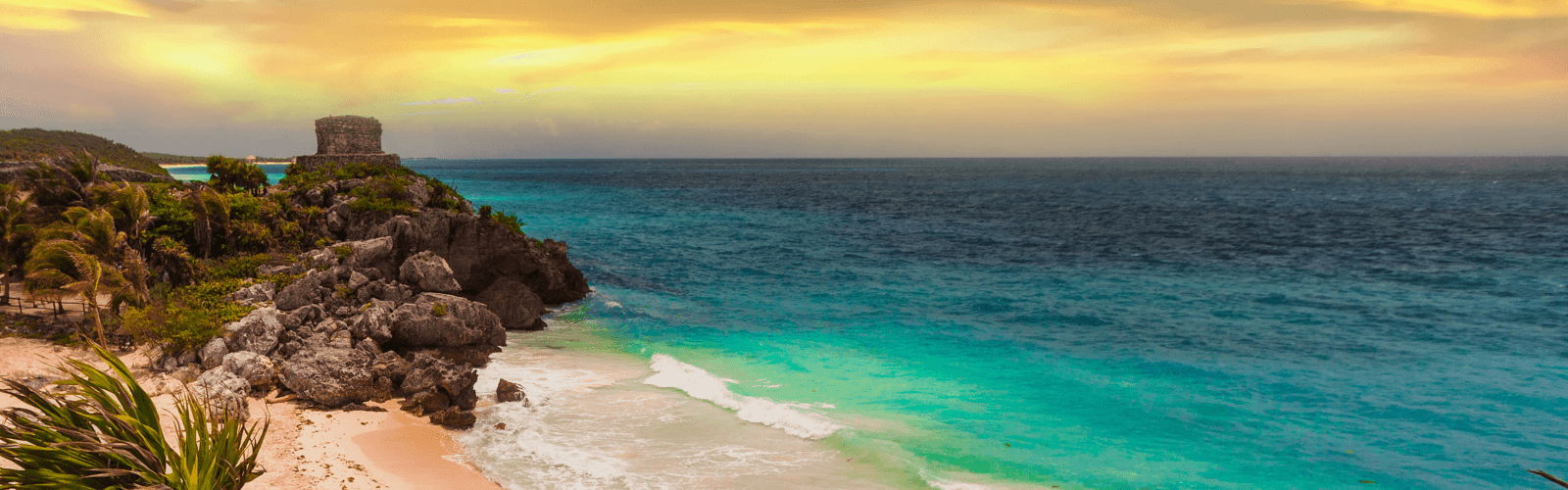 Mexico ruins on white sand beach and turquoise colored water