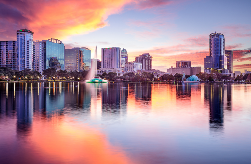 Stunning view of Orlando's Lake Eola and skyline during sunset.